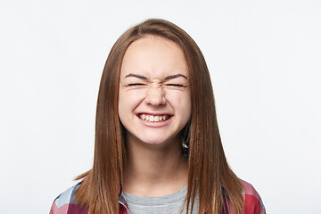 Image showing Happy emotional teen girl closing her eyes tight
