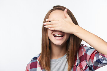 Image showing Emotional happy teen girl covering her eyes with palm