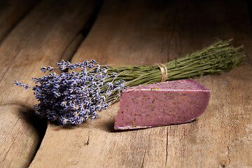 Image showing Lavender cheese with bunch of fresh lavender flowers on rough wooden planks