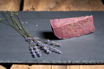 Image showing Lavender cheese with bunch of fresh lavender flowers on rough wooden planks