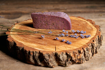 Image showing Lavender cheese with bunch of fresh lavender flowers on rough wooden planks