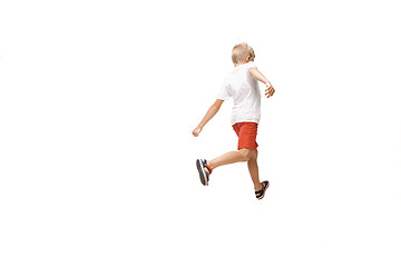 Image showing Happy little caucasian boy jumping and running isolated on white background