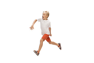 Image showing Happy little caucasian boy jumping and running isolated on white background