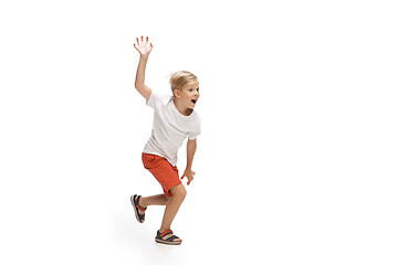 Image showing Happy little caucasian boy jumping and running isolated on white background