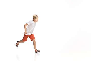 Image showing Happy little caucasian boy jumping and running isolated on white background