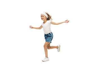 Image showing Happy little caucasian girl jumping and running isolated on white background