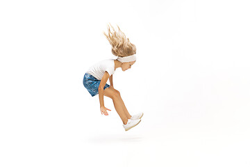 Image showing Happy little caucasian girl jumping and running isolated on white background