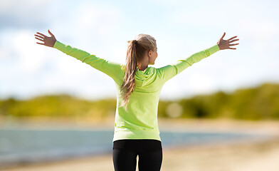 Image showing happy woman in sports clothes on beach