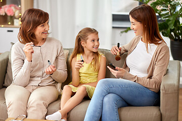 Image showing mother, daughter and grandmother doing make up