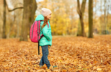 Image showing happy student girl with schoolbag at autumn park