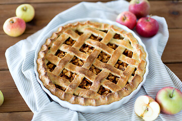 Image showing apple pie in baking mold on wooden table