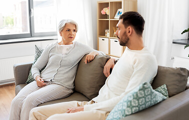 Image showing senior mother talking to adult son at home