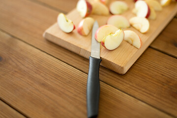 Image showing sliced apples and knife on wooden cutting board