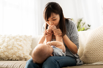 Image showing happy young mother with little baby son at home