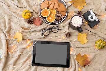 Image showing tablet computer, hot chocolate and autumn leaves
