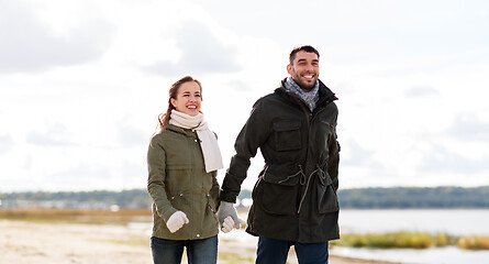 Image showing couple walking along autumn beach