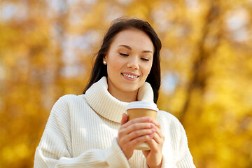 Image showing woman drinking takeaway coffee in autumn park