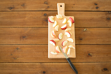 Image showing sliced apples and knife on wooden cutting board