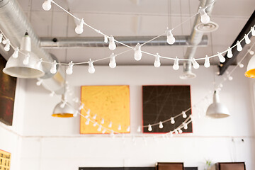 Image showing close up of garland bulbs at modern restaurant