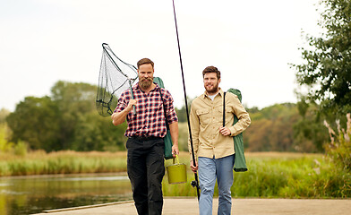 Image showing friends with fishing rods and net at lake or river