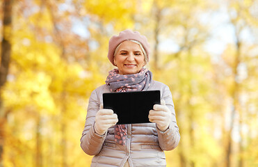 Image showing senior woman with tablet pc at summer park