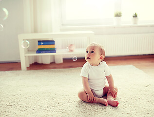 Image showing happy baby with soap bubbles at home