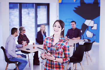 Image showing portrait of young business woman at office with team in backgrou