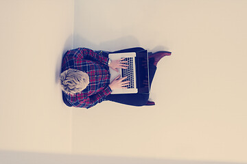 Image showing top view of young business woman working on laptop computer