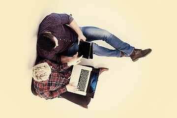 Image showing top view of  couple working on laptop computer at startup office