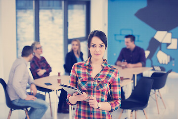 Image showing portrait of young business woman at office with team in backgrou