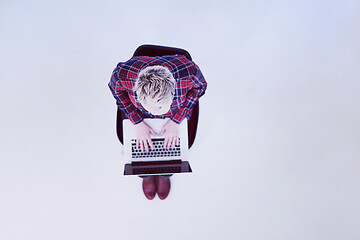 Image showing top view of young business woman working on laptop computer