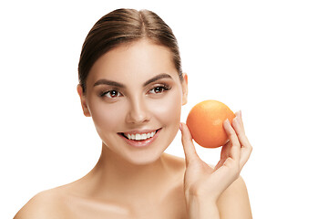 Image showing portrait of attractive caucasian smiling woman isolated on white studio shot eating green apple