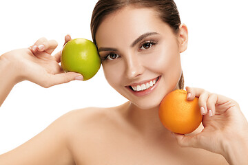 Image showing portrait of attractive caucasian smiling woman isolated on white studio shot eating green apple