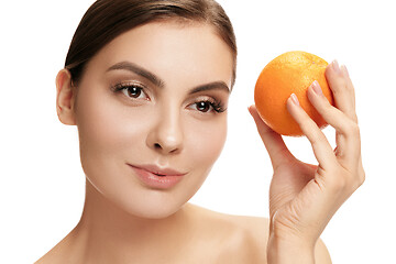 Image showing portrait of attractive caucasian smiling woman isolated on white studio shot eating green apple