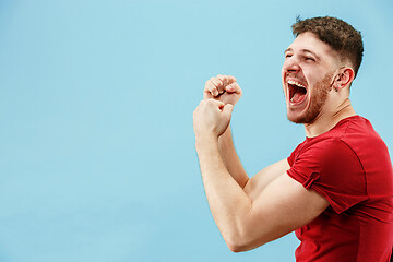 Image showing Winning success man happy ecstatic celebrating being a winner. Dynamic energetic image of male model