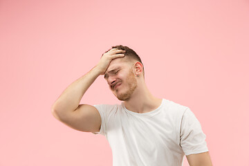 Image showing Man having headache. Isolated over pink background.