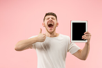 Image showing portrait of smiling man pointing at laptop with blank screen isolated on white