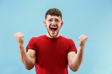 Image showing Winning success man happy ecstatic celebrating being a winner. Dynamic energetic image of male model