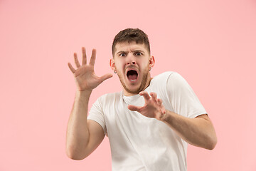 Image showing Portrait of the scared man on pink