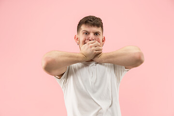 Image showing Beautiful man looking suprised and bewildered isolated on pink