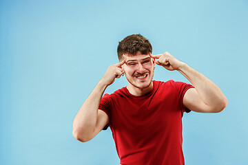 Image showing Young boy with a surprised expression bet slip on blue background