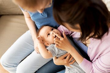 Image showing happy mixed-race family with baby son at home