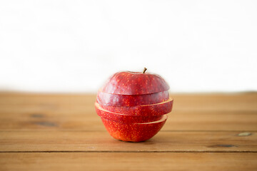 Image showing sliced red apple on wooden table