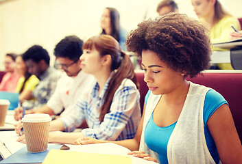 Image showing group of students with coffee writing on lecture