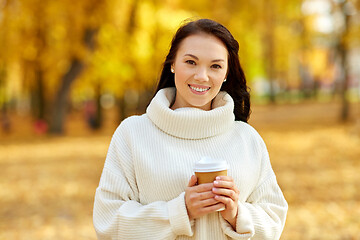 Image showing woman drinking takeaway coffee in autumn park