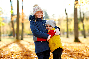 Image showing happy children hugging at autumn park