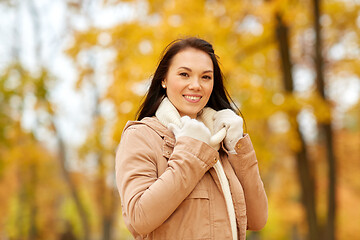 Image showing beautiful happy young woman smiling in autumn park