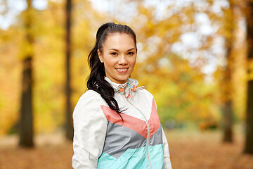 Image showing young woman in sports clothing at autumn park