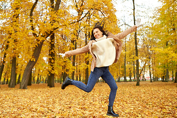 Image showing beautiful happy young woman in autumn park