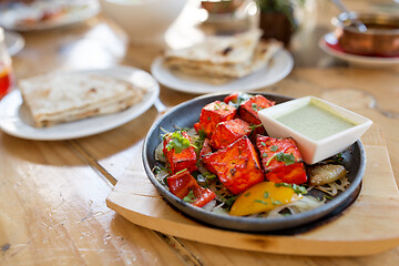 Image showing close up of paneer tikka dish with sauce on table